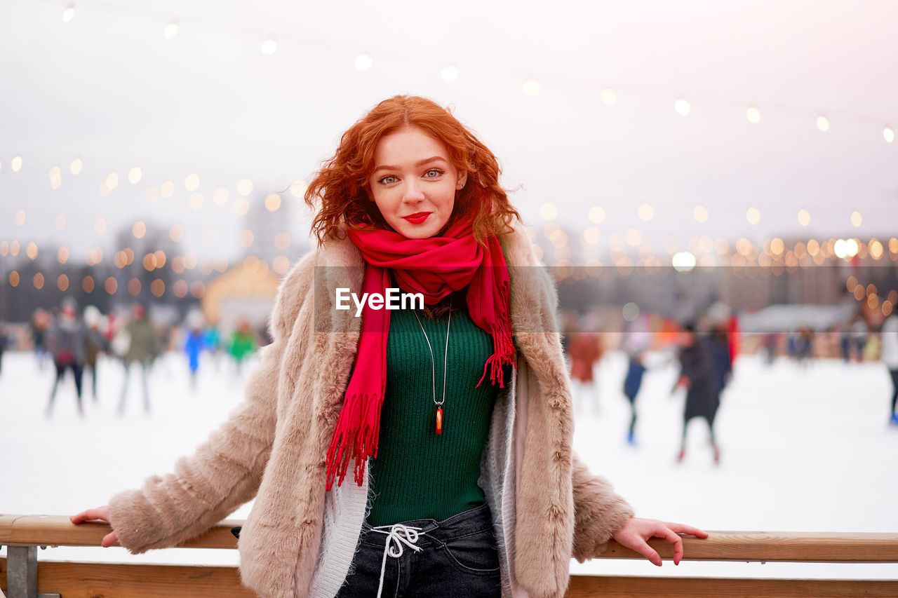 Portrait of smiling young woman standing outdoors