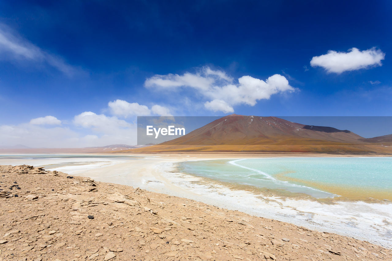 Scenic view of beach against blue sky