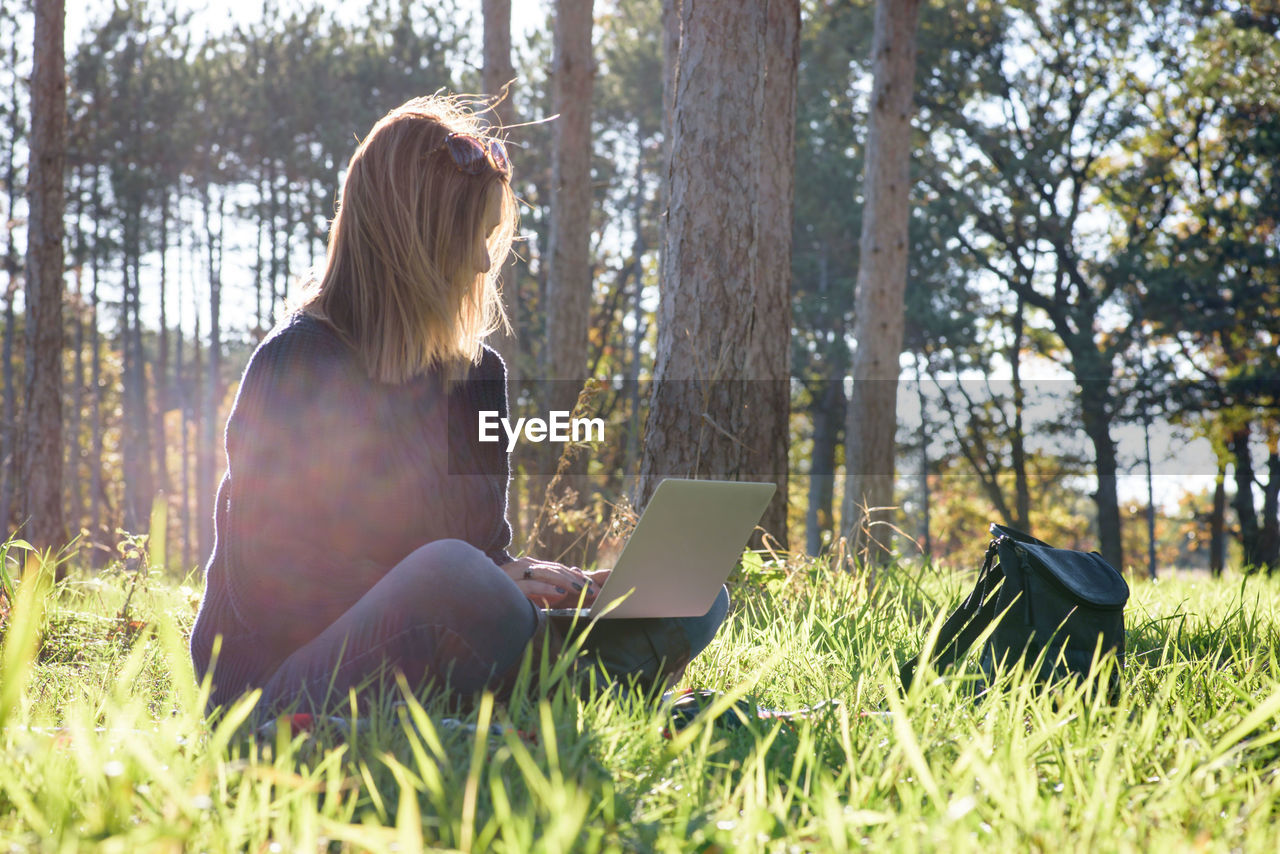 Woman using laptop at park