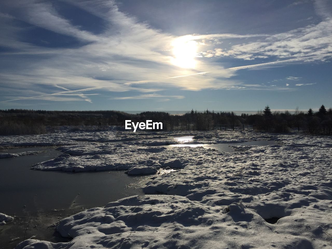 Scenic view of land against sky during winter