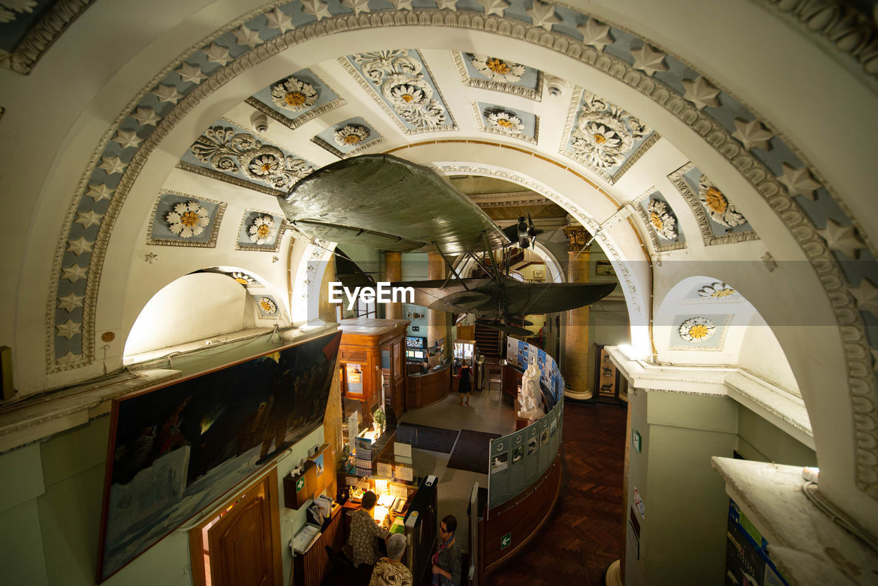 LOW ANGLE VIEW OF ILLUMINATED CEILING IN OLD BUILDING