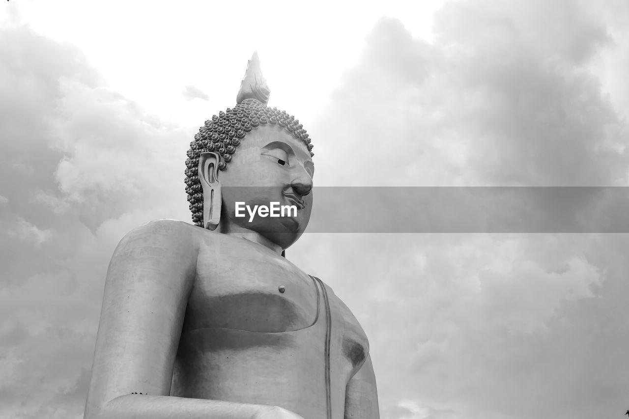 LOW ANGLE VIEW OF STATUE OF BUDDHA AGAINST SKY