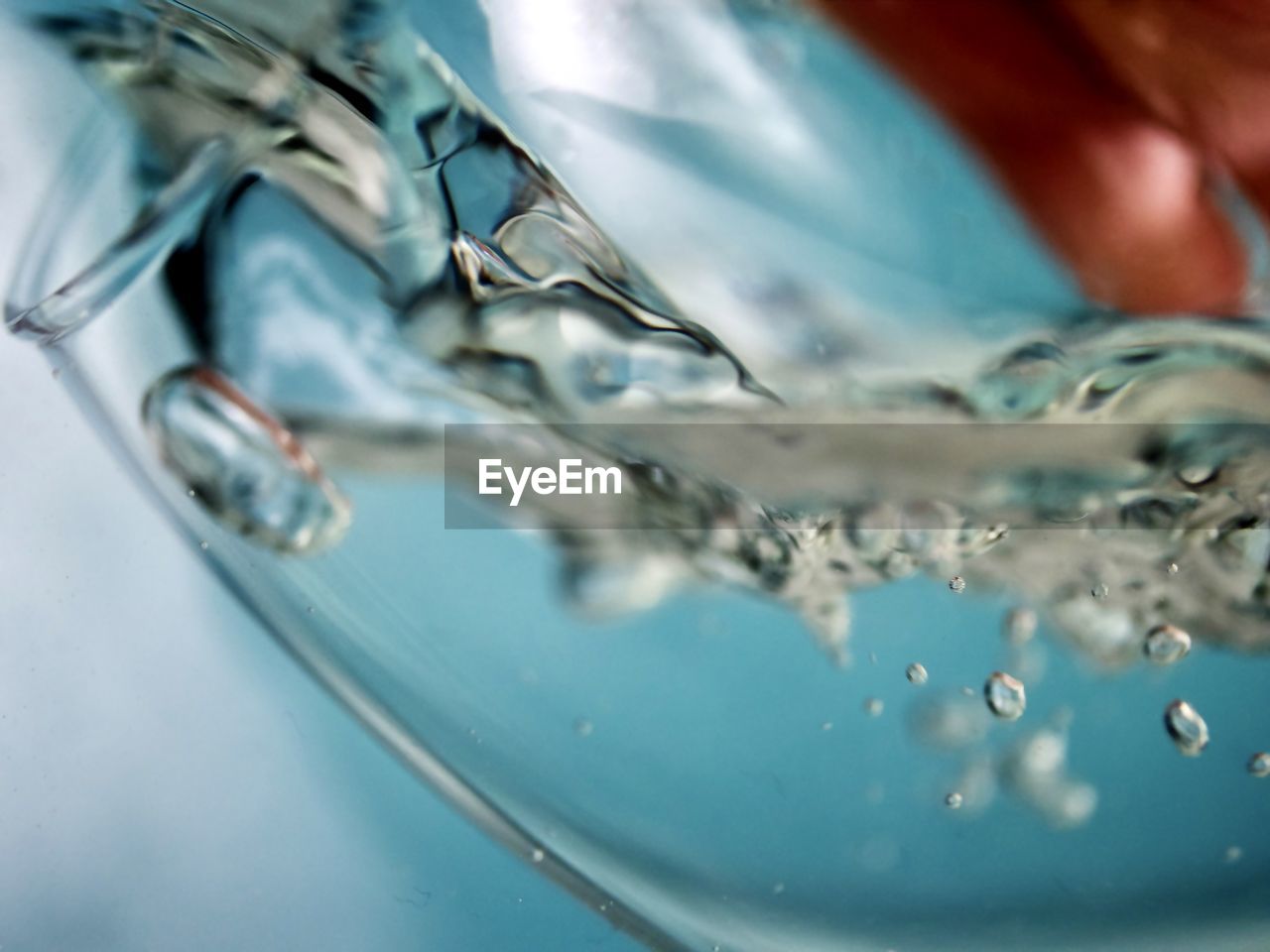 Close-up of water dropping into glass