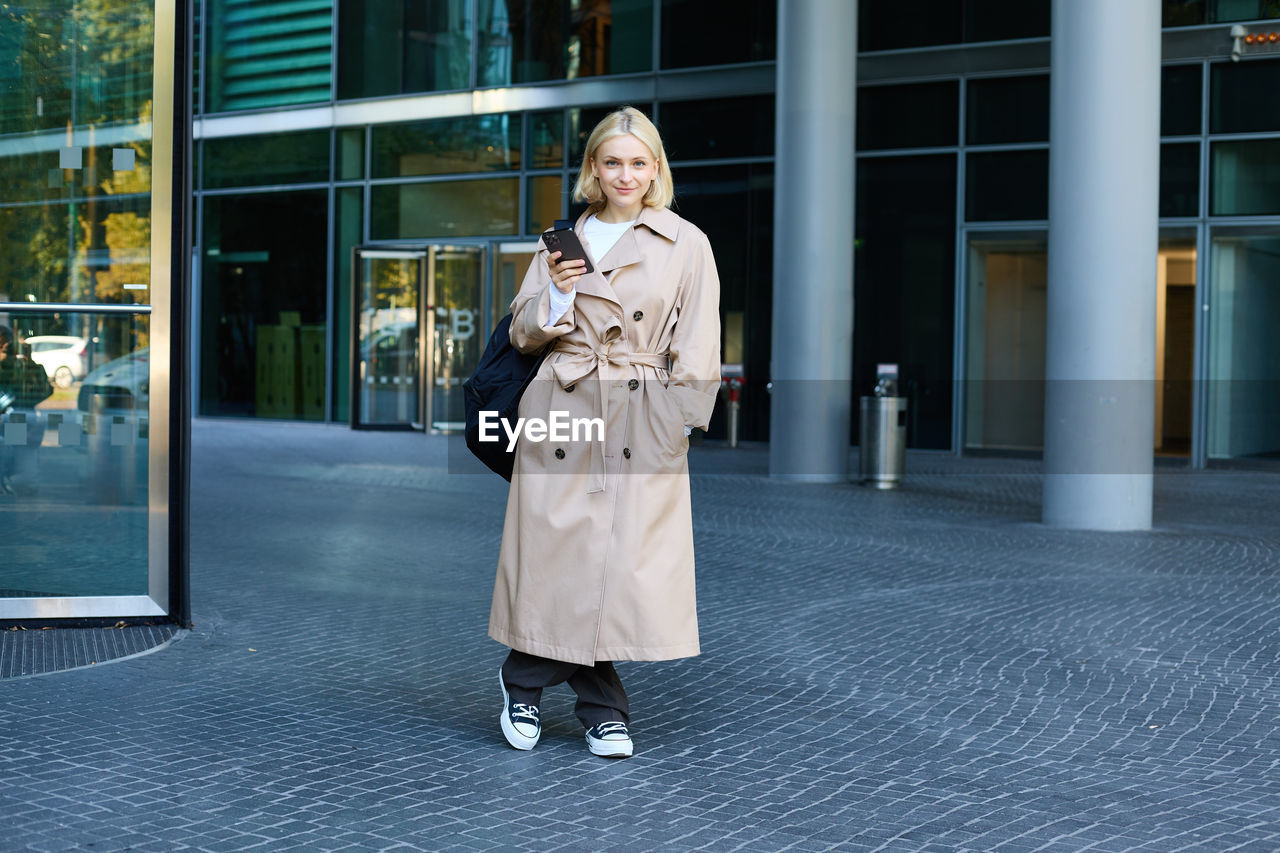 portrait of young woman walking on street