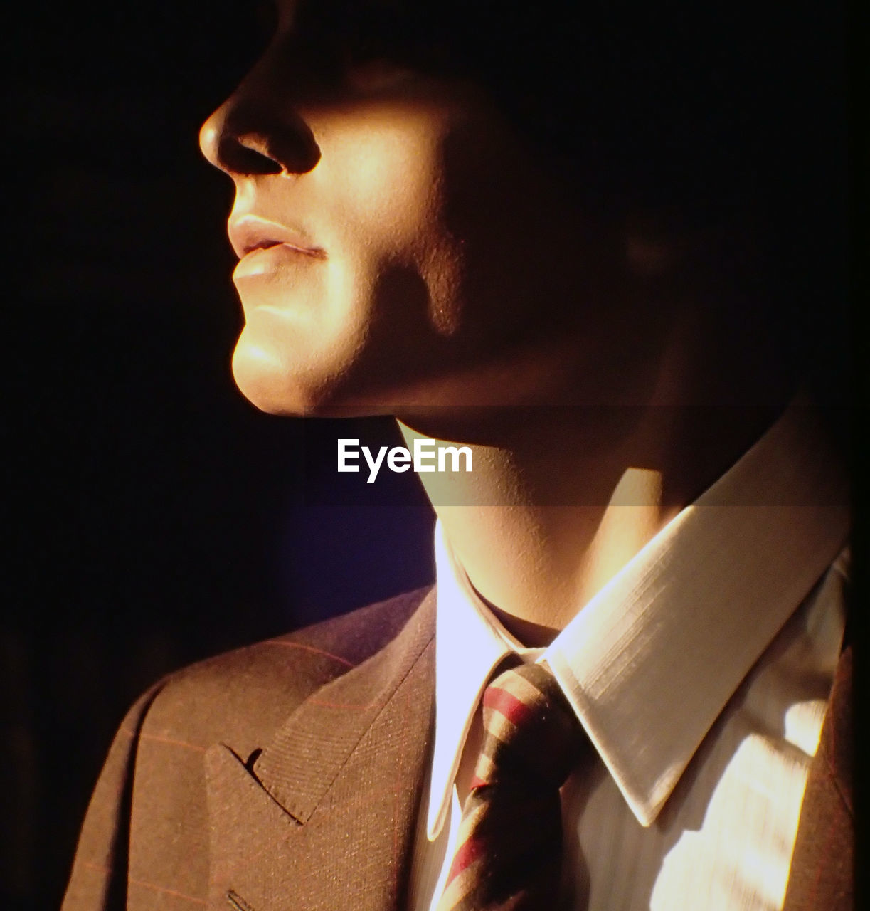 Sunlight falling on mannequin with necktie