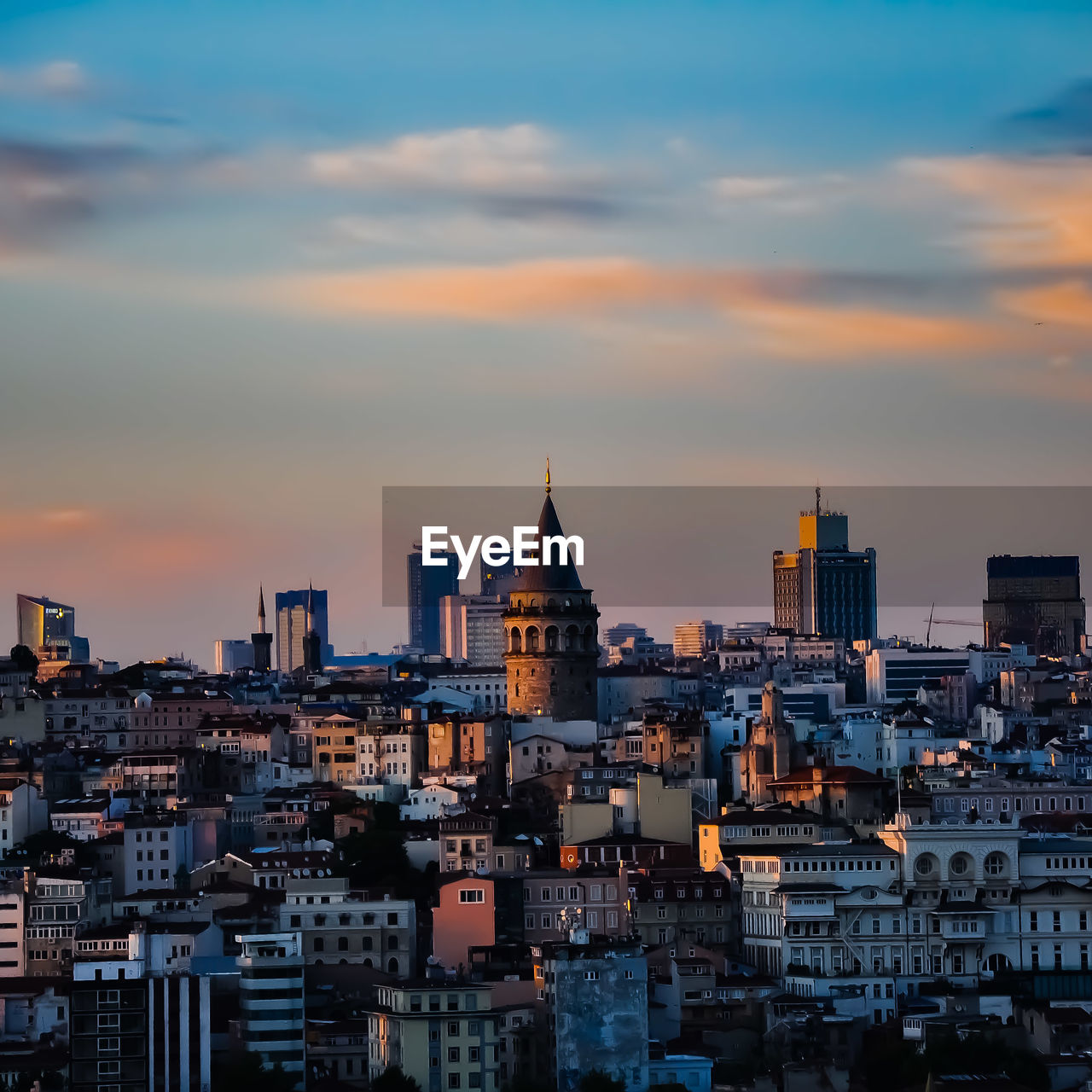 Buildings in city at sunset