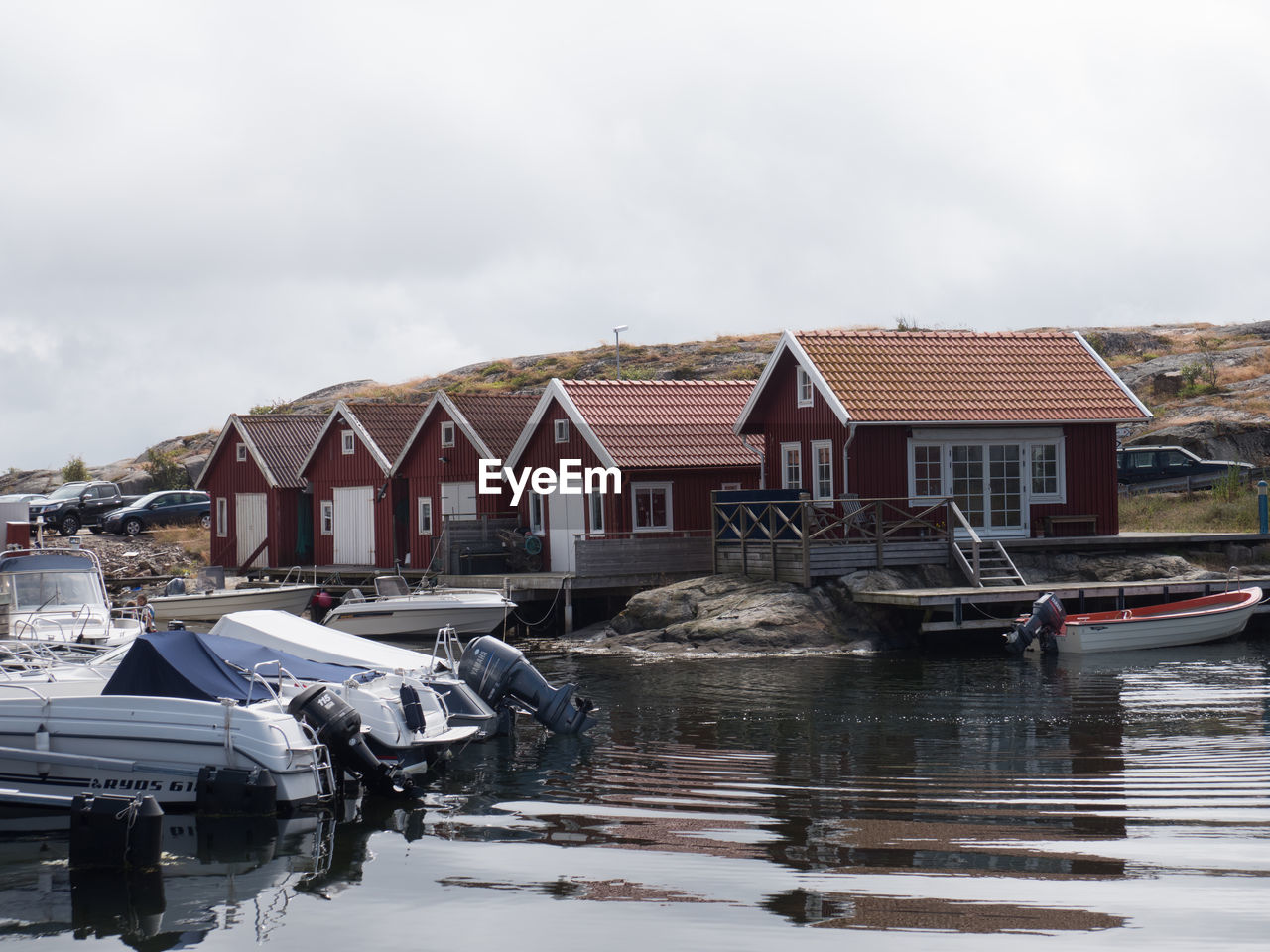 HOUSES BY LAKE AGAINST BUILDING