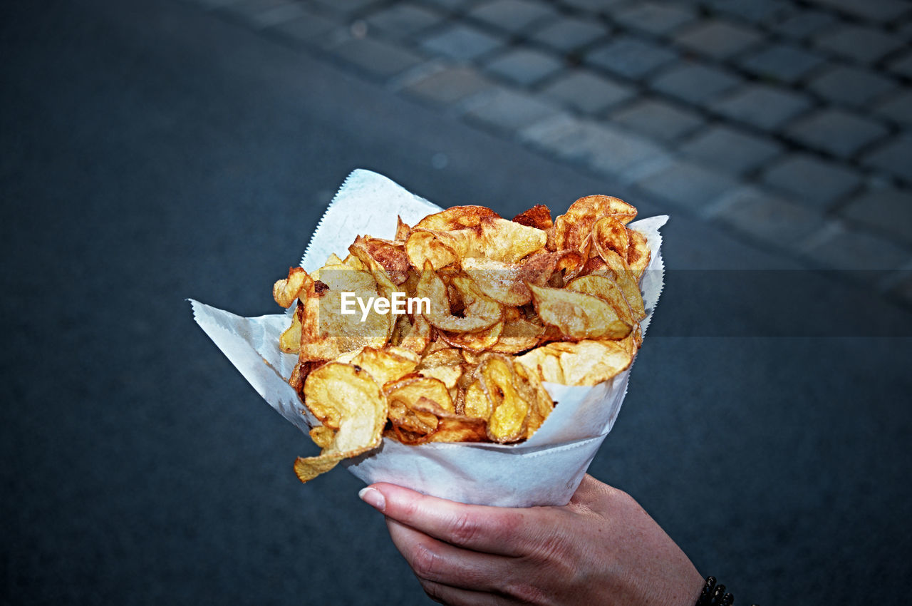 Cropped hand holding prepared potatoes