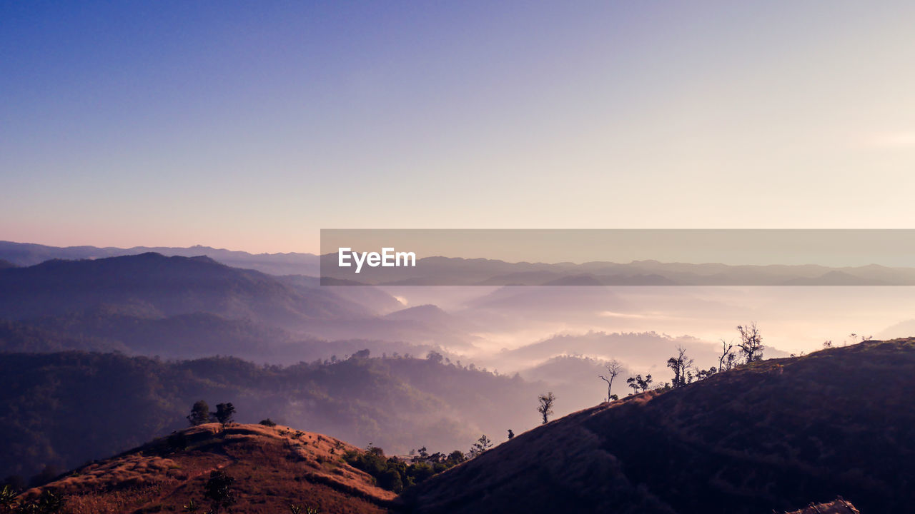 Scenic view of mountains against sky during sunset on the morning