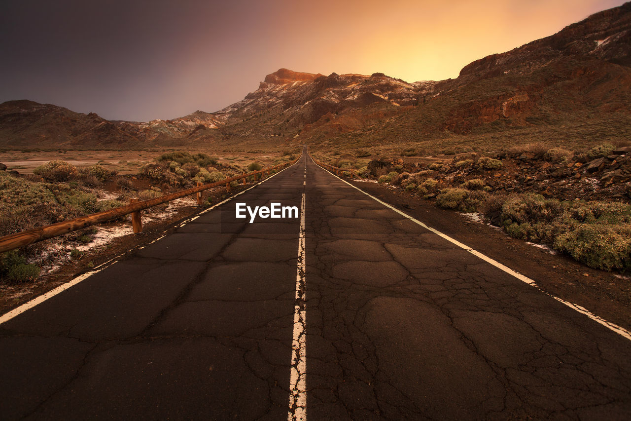 Road amidst mountains against clear sky