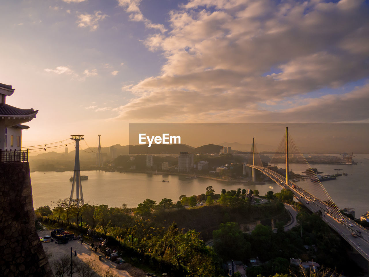 BRIDGE OVER RIVER DURING SUNSET