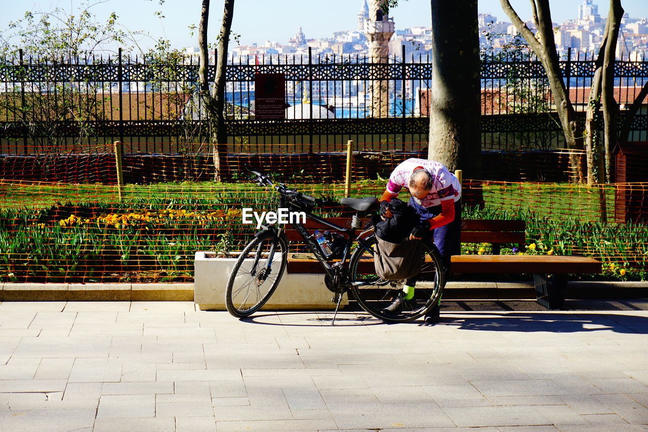 WOMAN RIDING BICYCLE ON CITY STREET