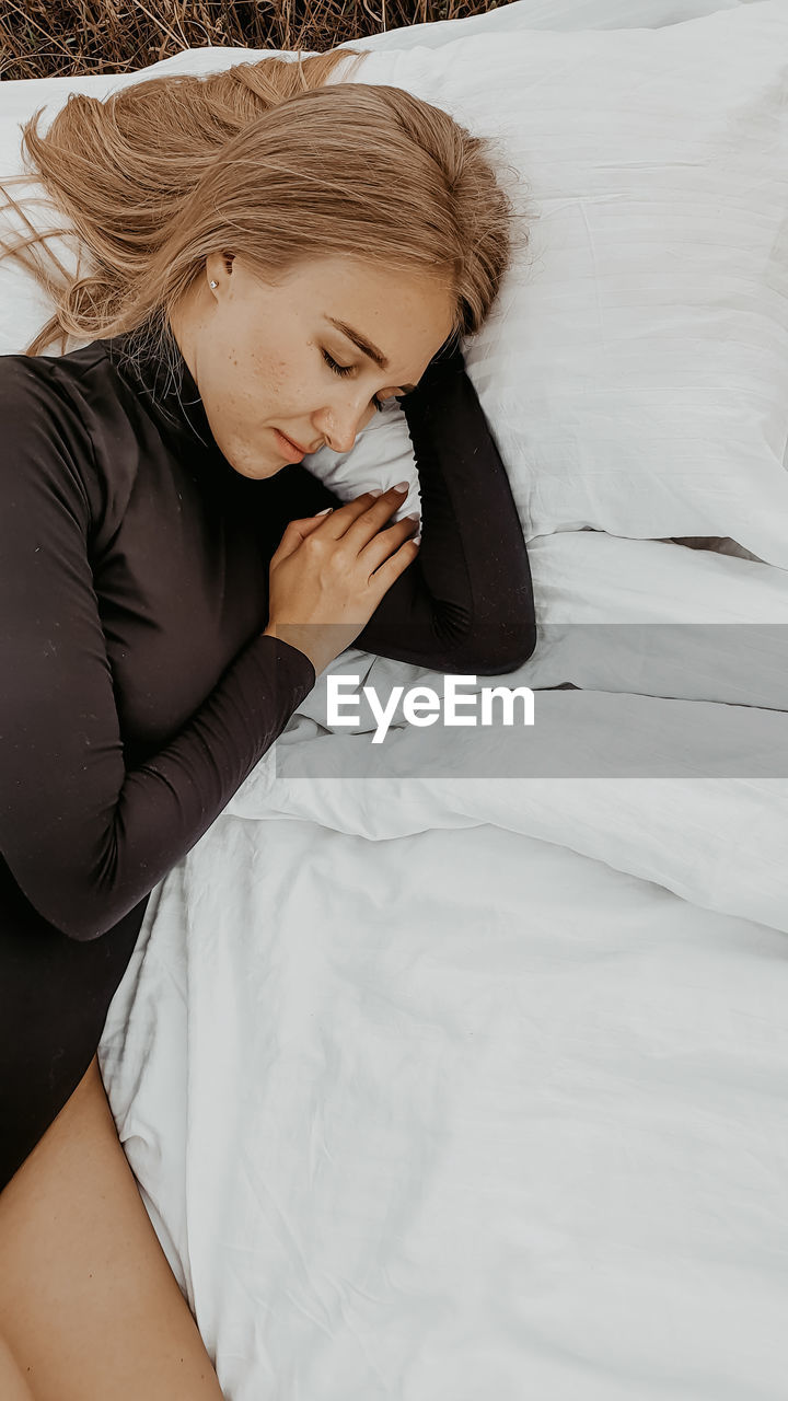 High angle view of woman lying on blanket