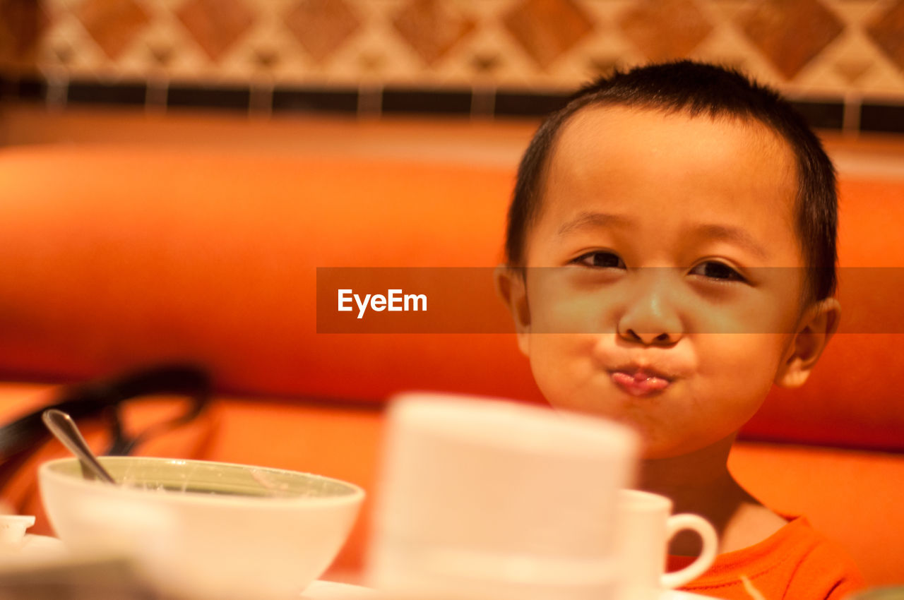 Portrait of boy making a face at restaurant