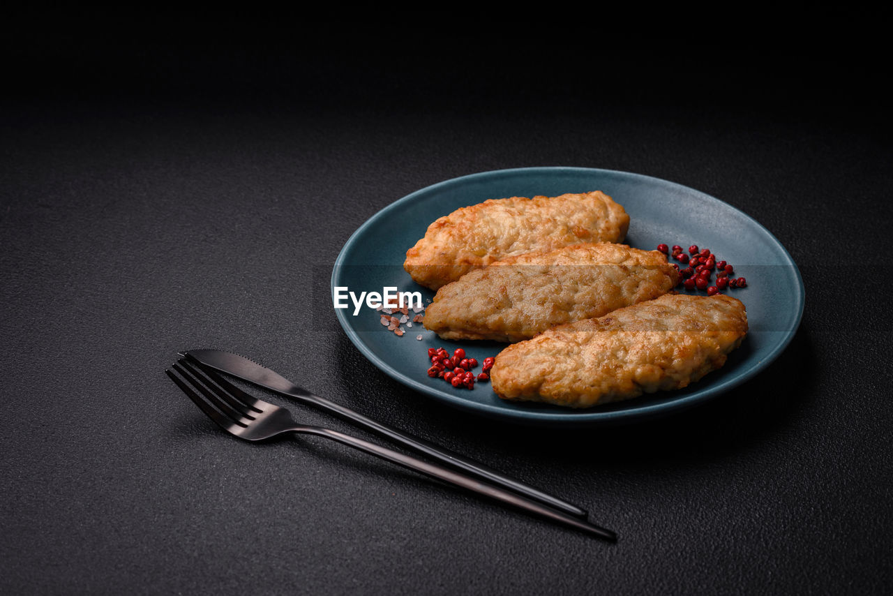 food and drink, food, studio shot, korokke, plate, black background, indoors, fast food, croquette, fork, no people, fried food, freshness, kitchen utensil, eating utensil, dish, meal, fried, sweet food, healthy eating, meat, copy space, still life, produce