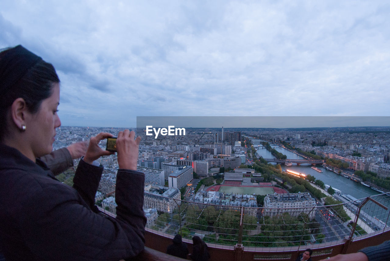 MIDSECTION OF MAN WITH CITYSCAPE IN BACKGROUND