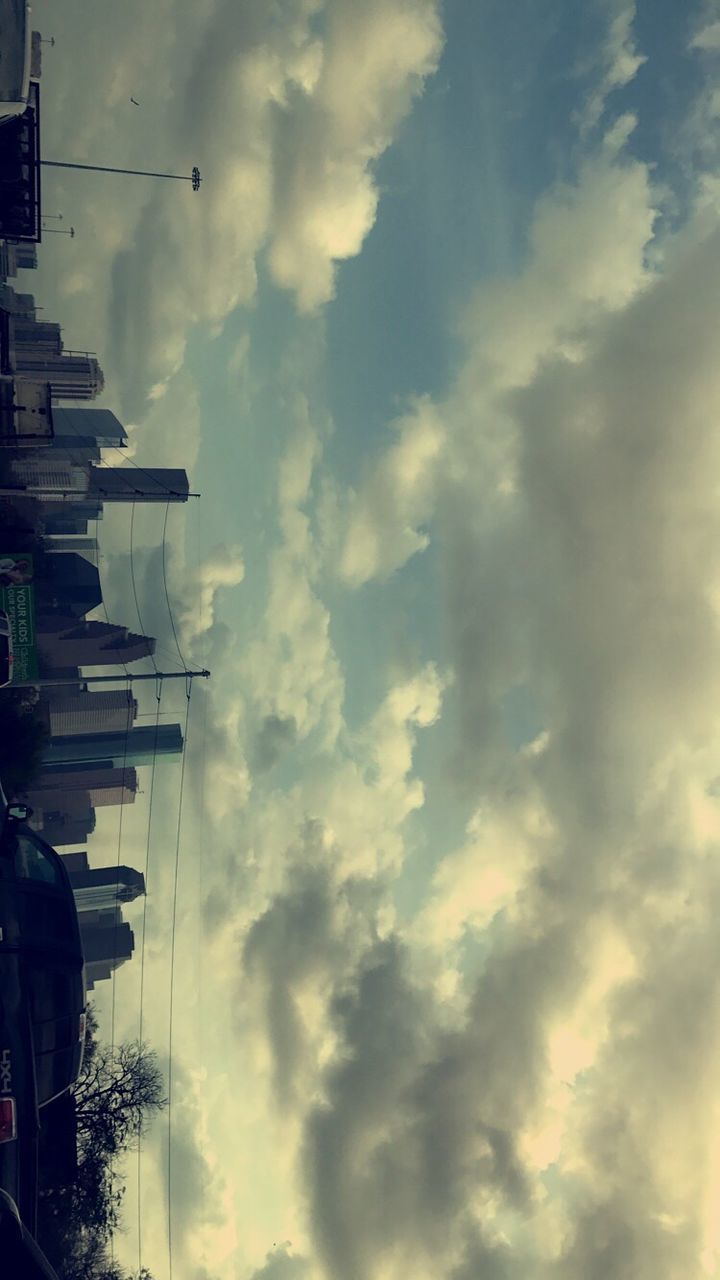 LOW ANGLE VIEW OF BUILDINGS AGAINST CLOUDY SKY