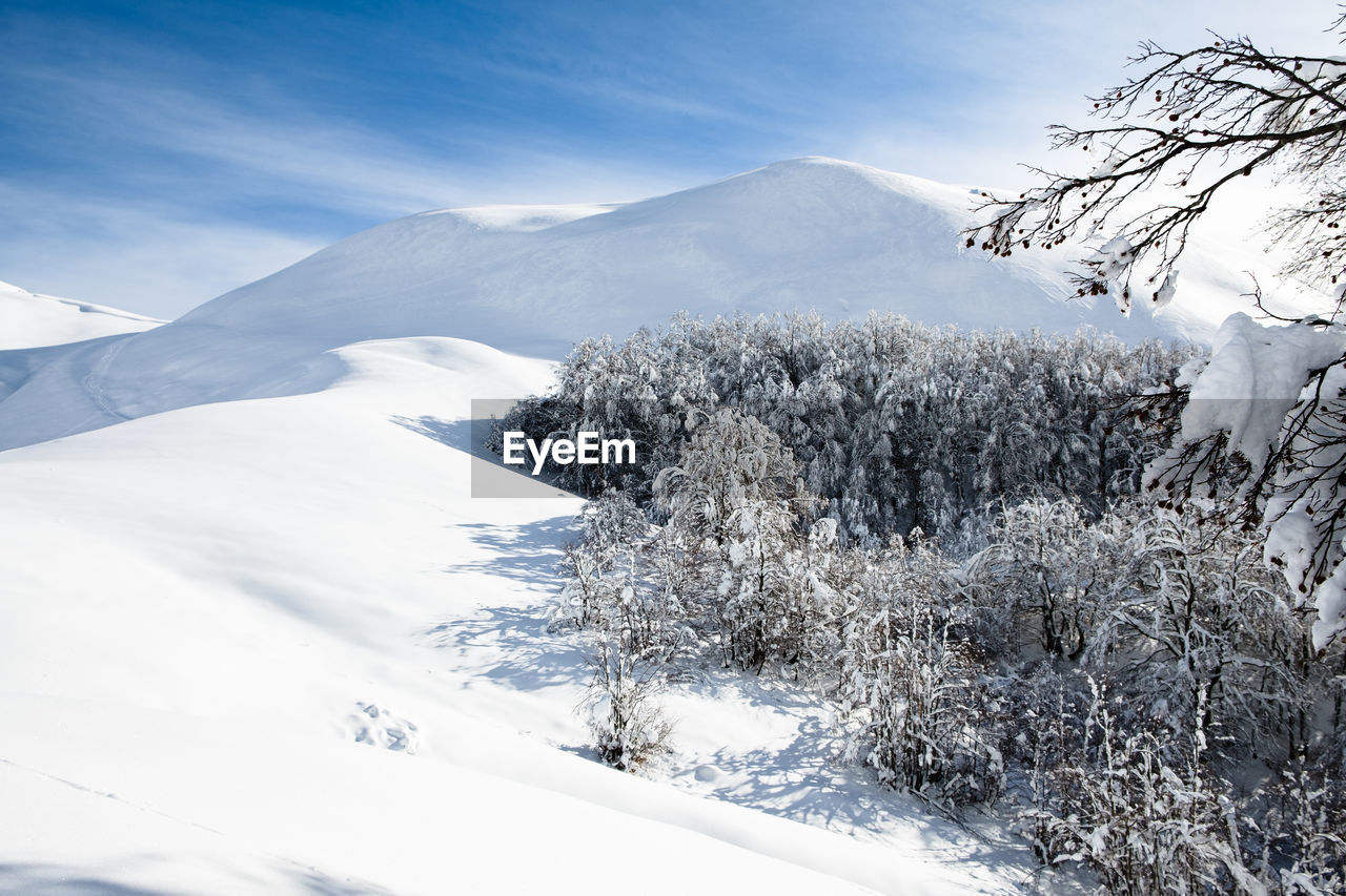 Scenic view of snow covered mountains against sky in micigliano, lazio italy 