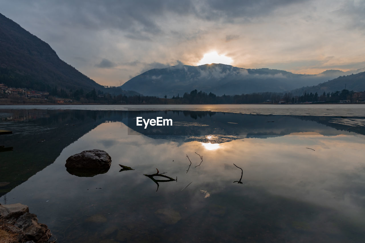 Scenic view of lake against sky during sunset