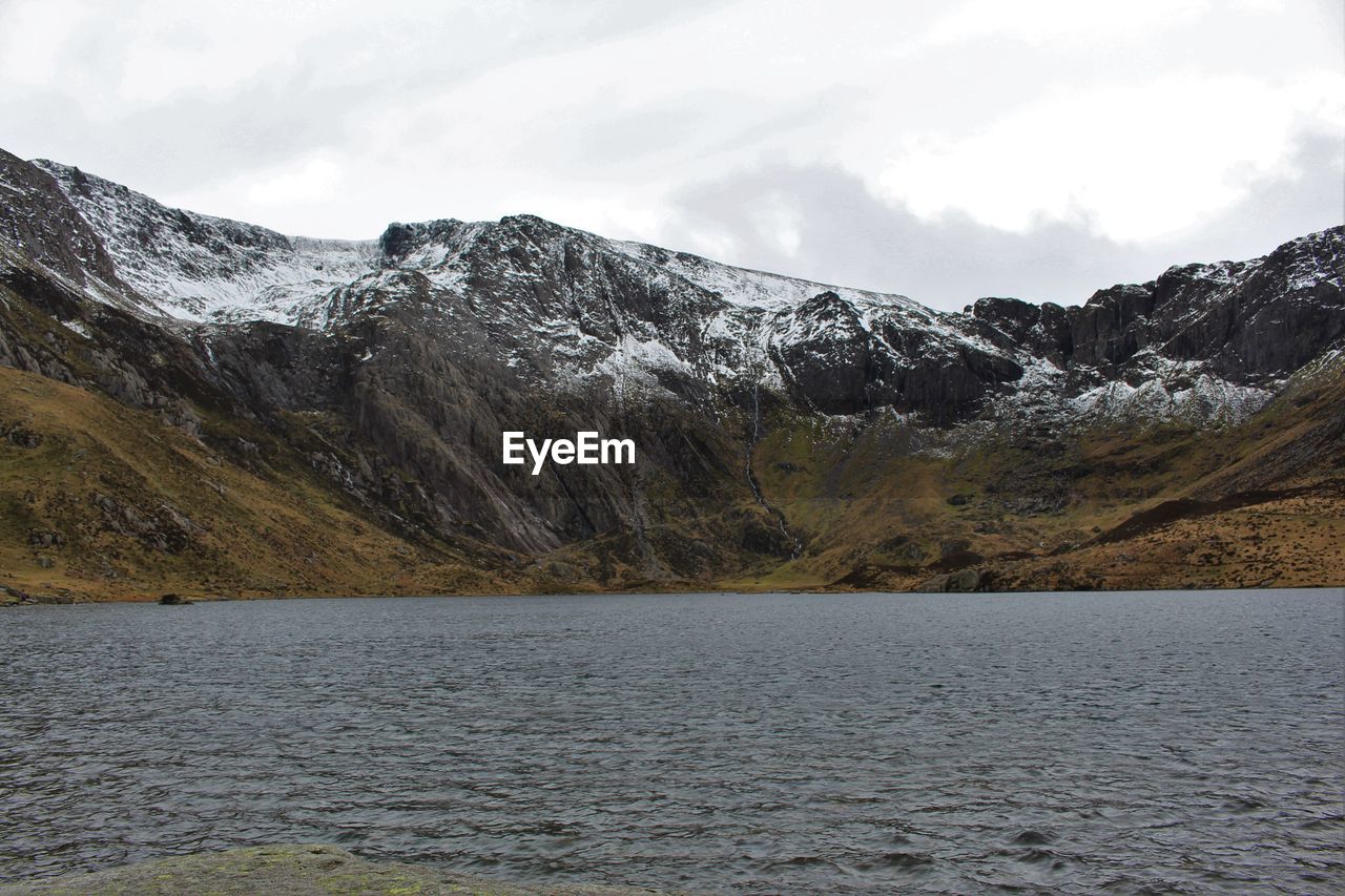 Scenic view of mountains against cloudy sky