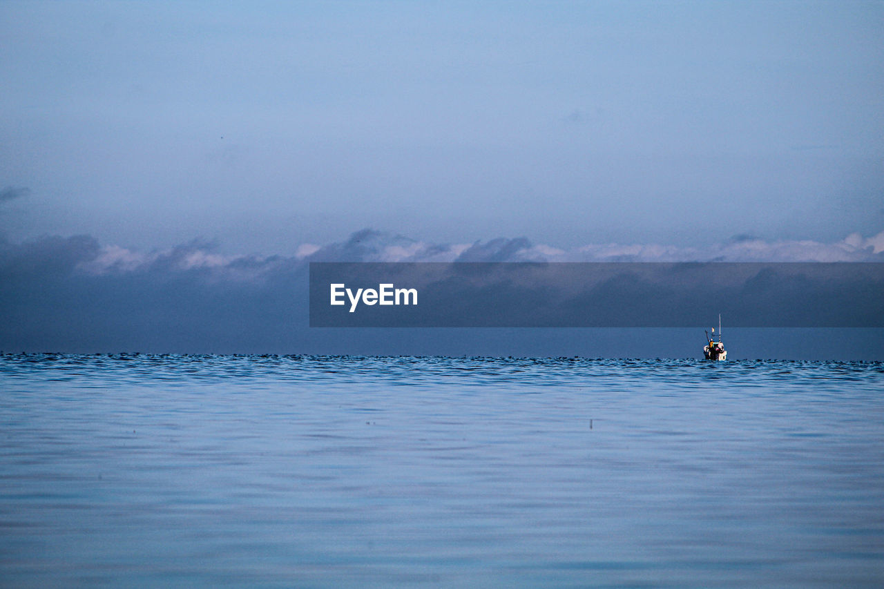 Sailboat in sea against sky