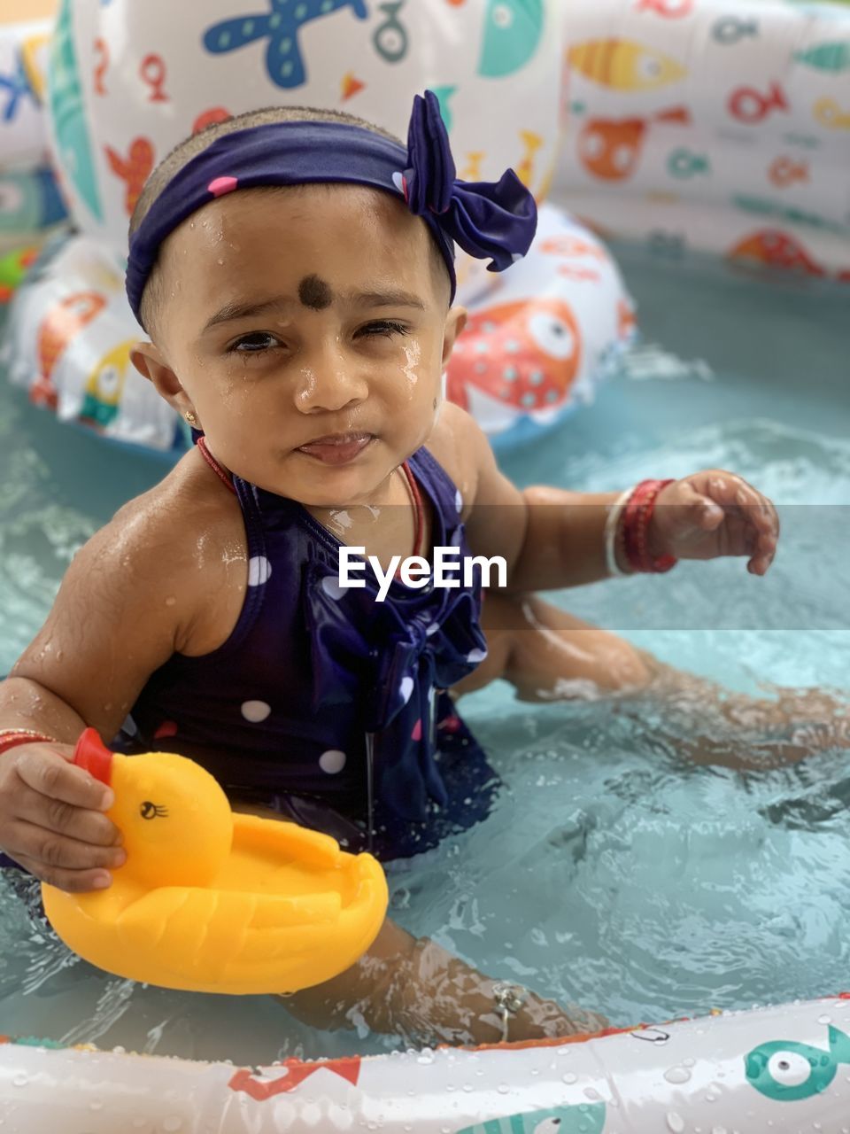 Portrait of cute girl in swimming pool