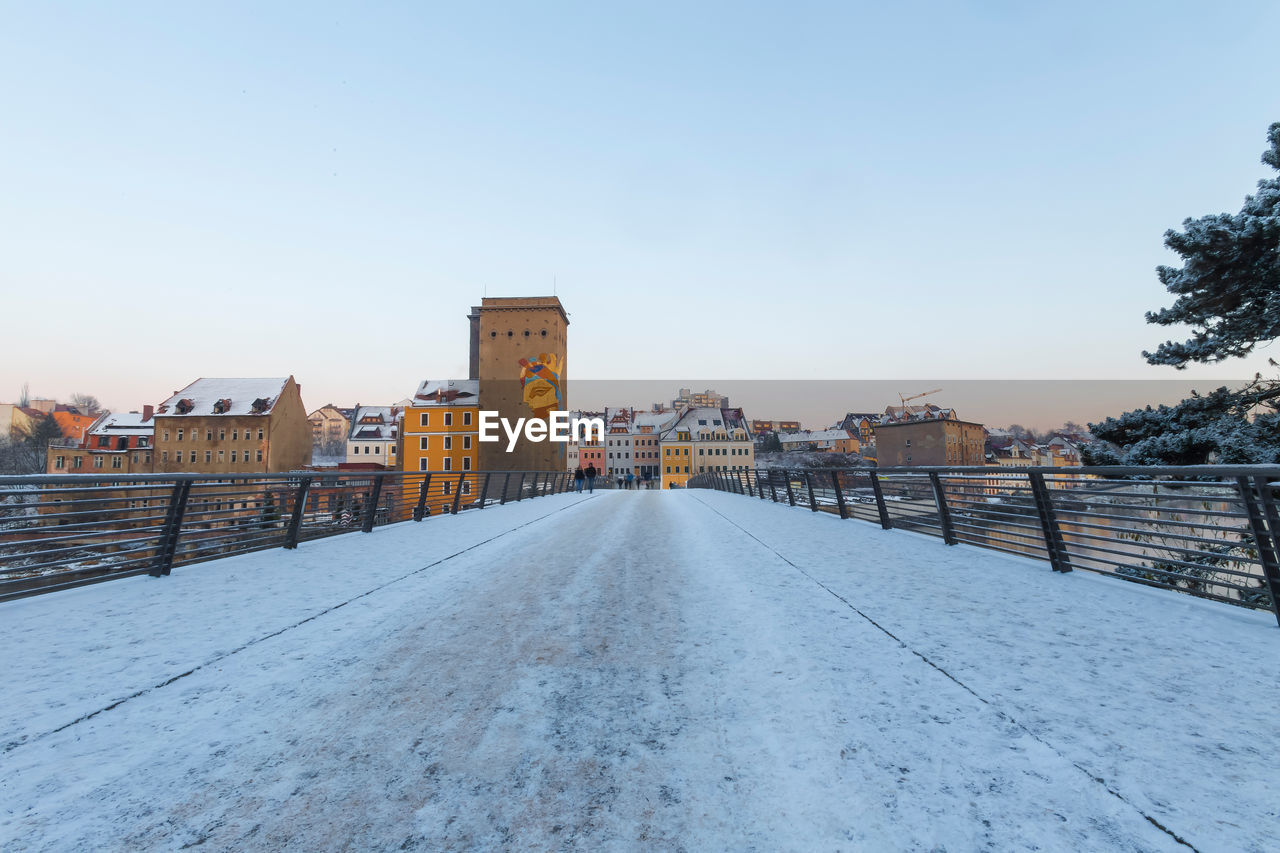 View of buildings in city against clear sky