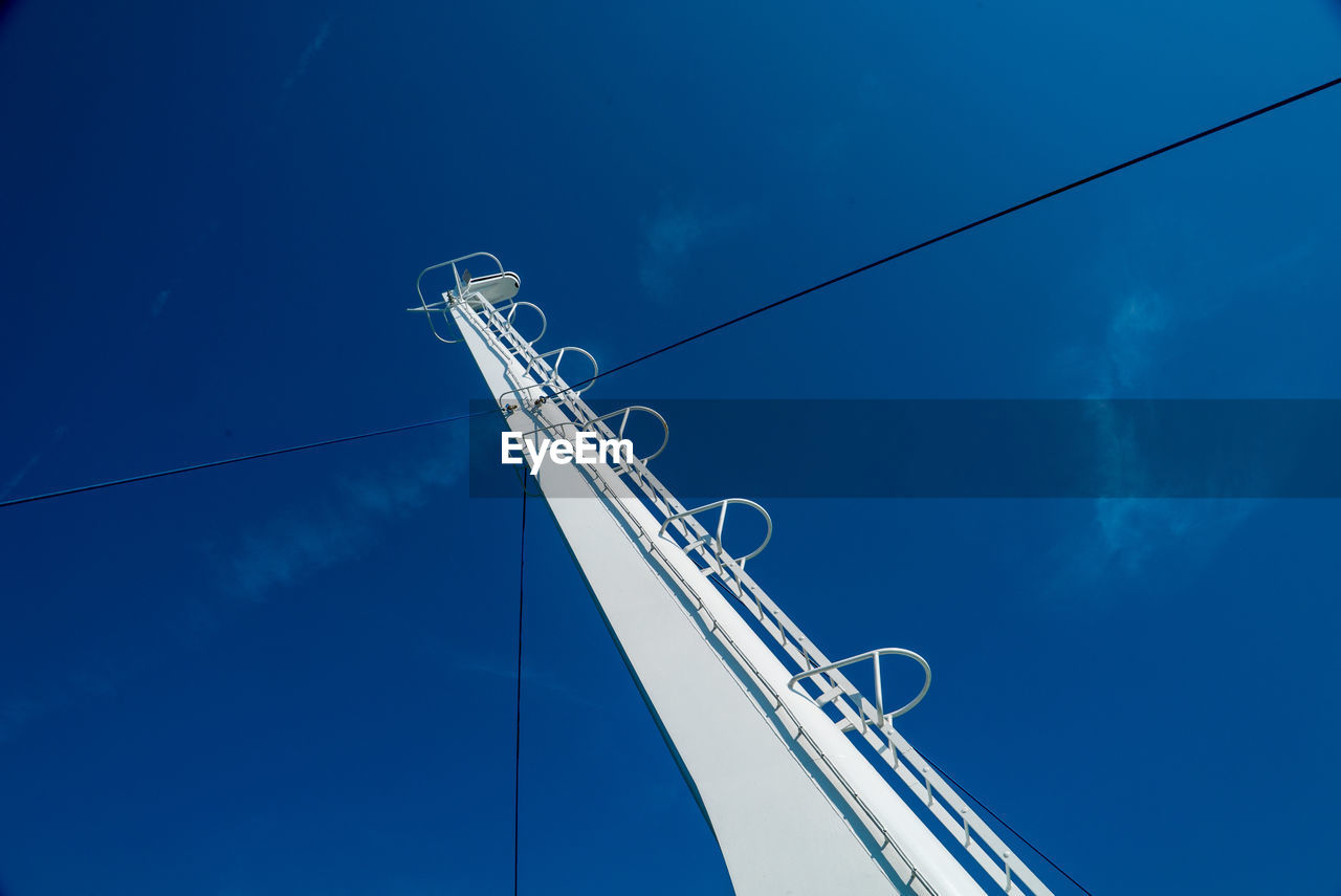 Low angle view of pole against blue sky