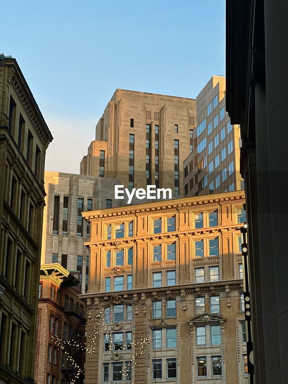 architecture, building exterior, built structure, urban area, city, building, downtown, neighbourhood, cityscape, tower block, window, facade, metropolis, sky, landmark, skyscraper, residential district, office building exterior, travel destinations, no people, metropolitan area, nature, low angle view, office, clear sky, apartment, travel, outdoors, city life, street, business finance and industry, day