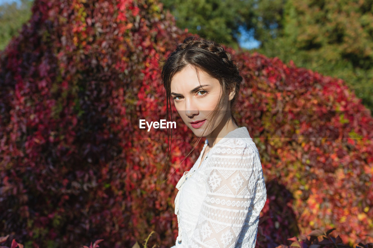 Beautiful young woman in a white lace blouse in an autumn park. summer or fall lifestyle portrait 