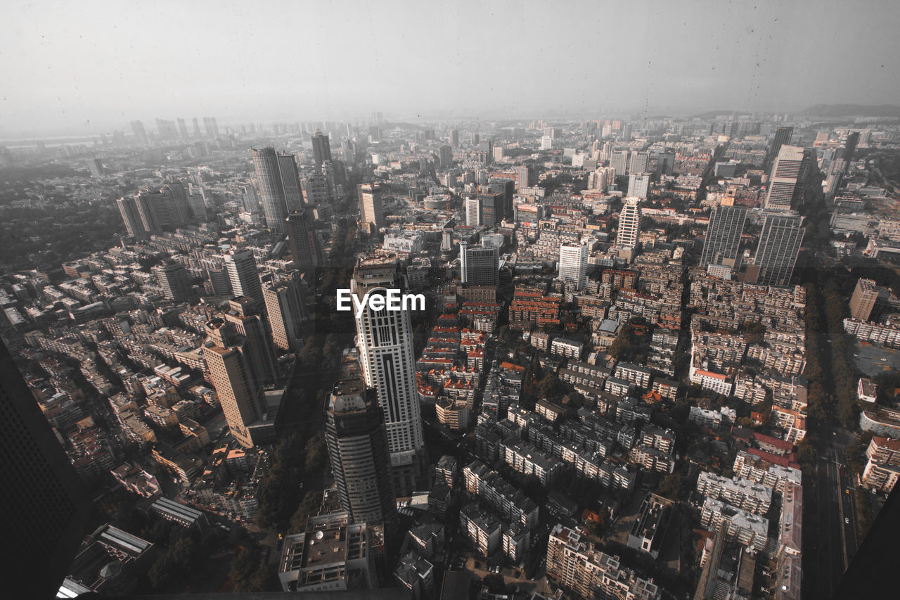 High angle view of modern buildings in city against sky