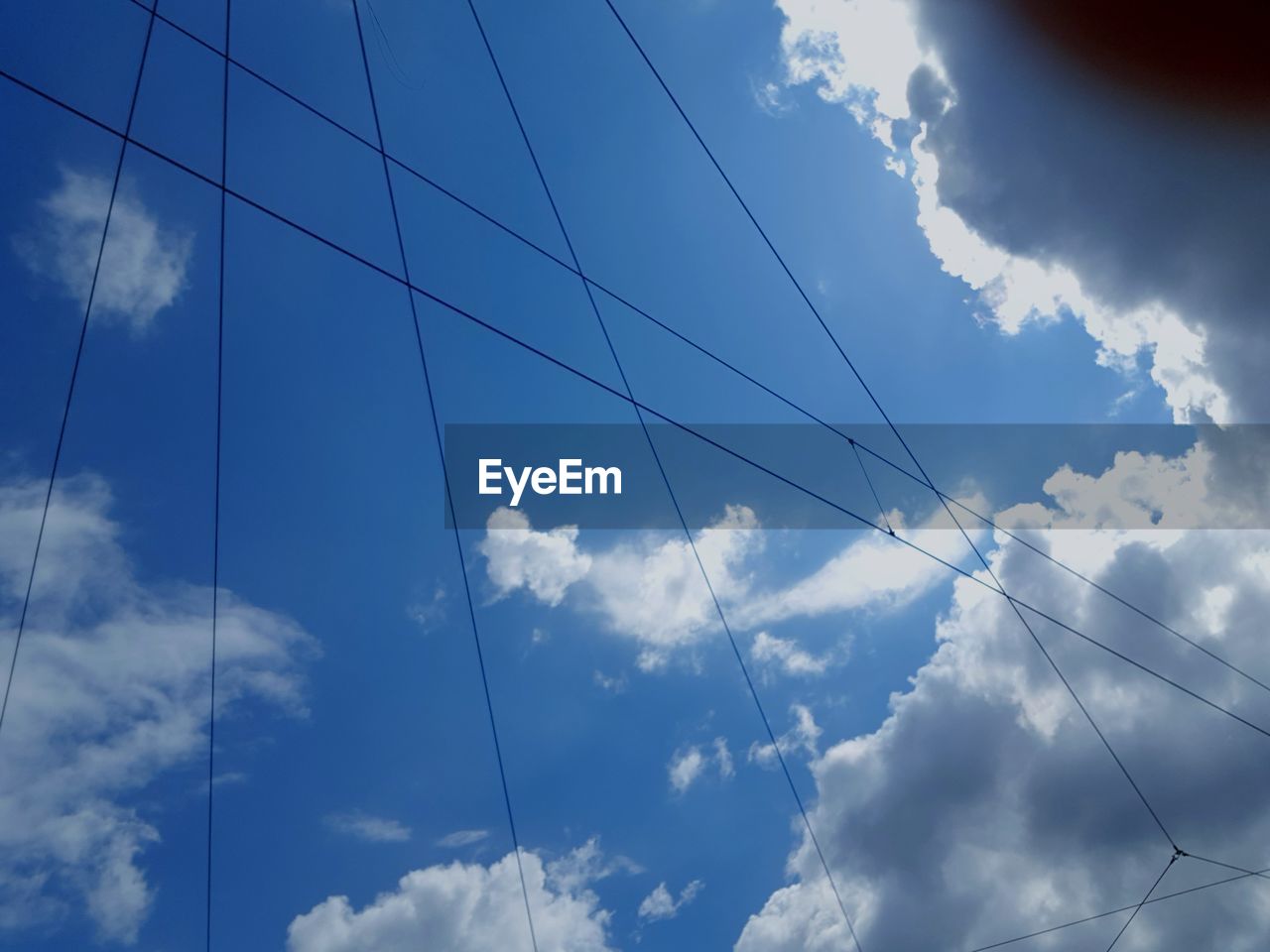 LOW ANGLE VIEW OF POWER LINES AGAINST SKY