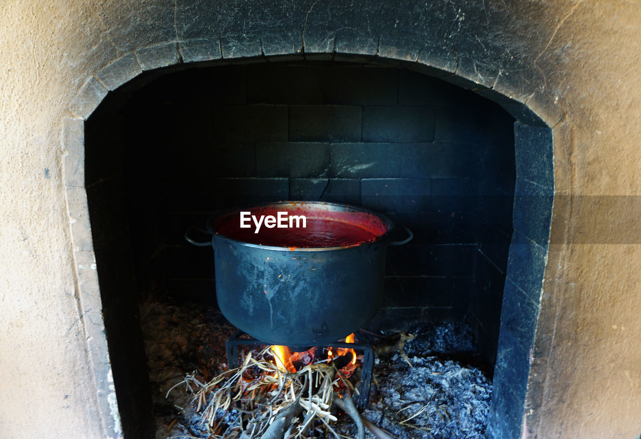 Traditional tomato paste production in the fireplace