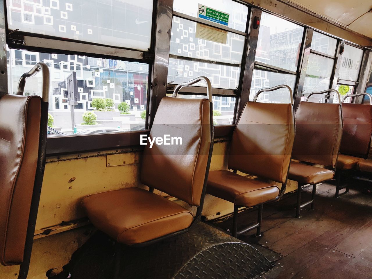 EMPTY CHAIRS AND TRAIN IN WINDOW