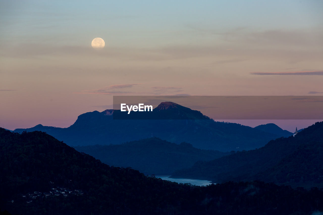 Scenic view of silhouette mountains against sky at sunset