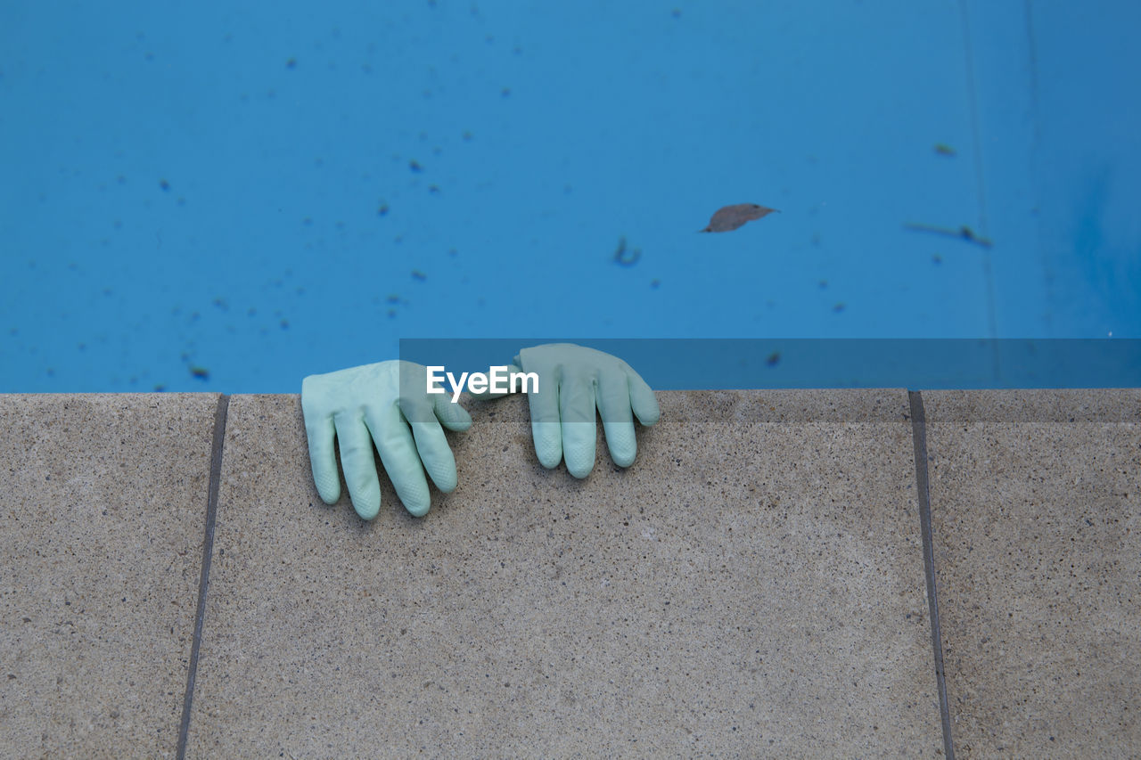 Close-up of human hand on wall