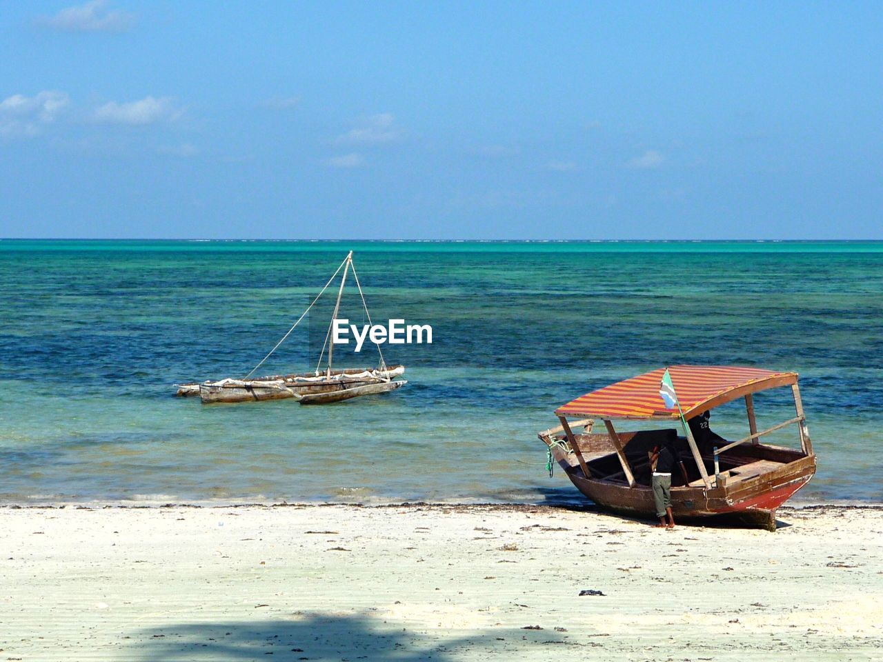 Boats moored at shore against sky