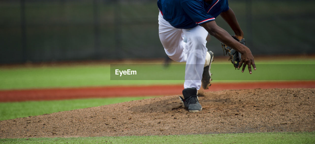 Low section of baseball player standing on playing field