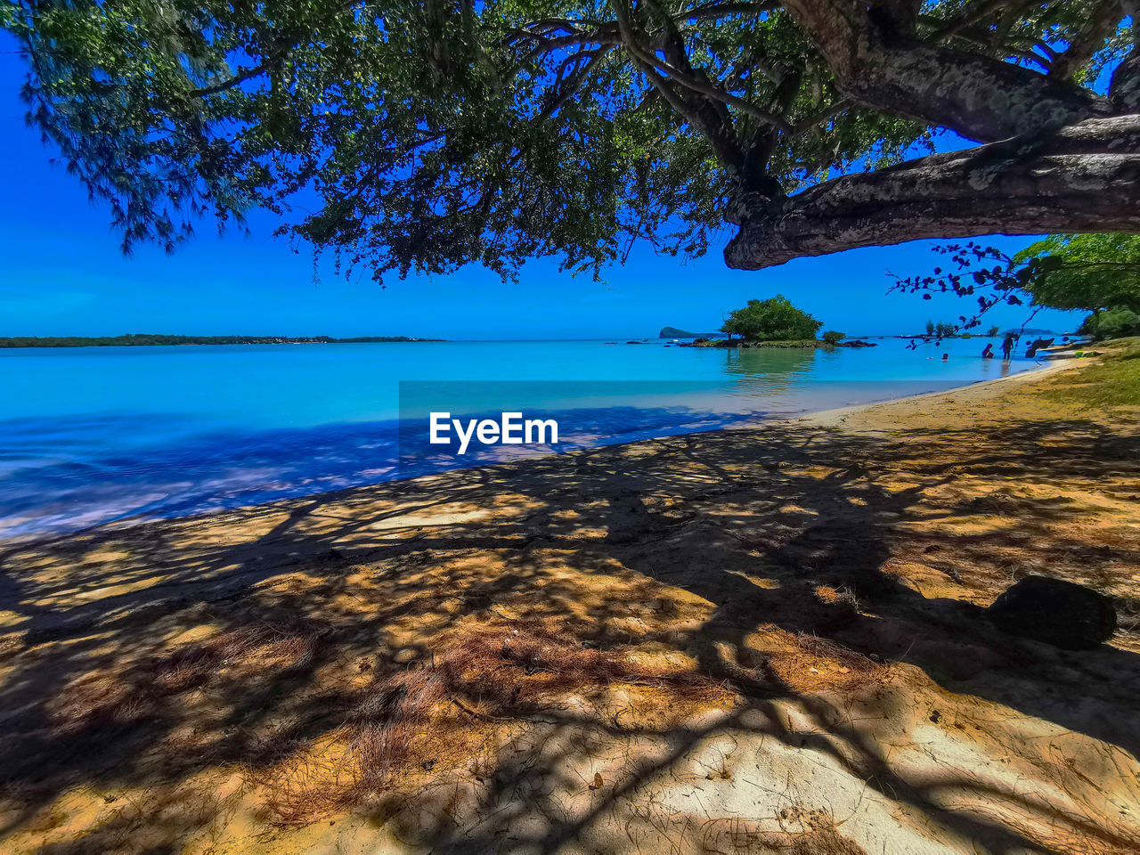 Scenic view of sea against blue sky