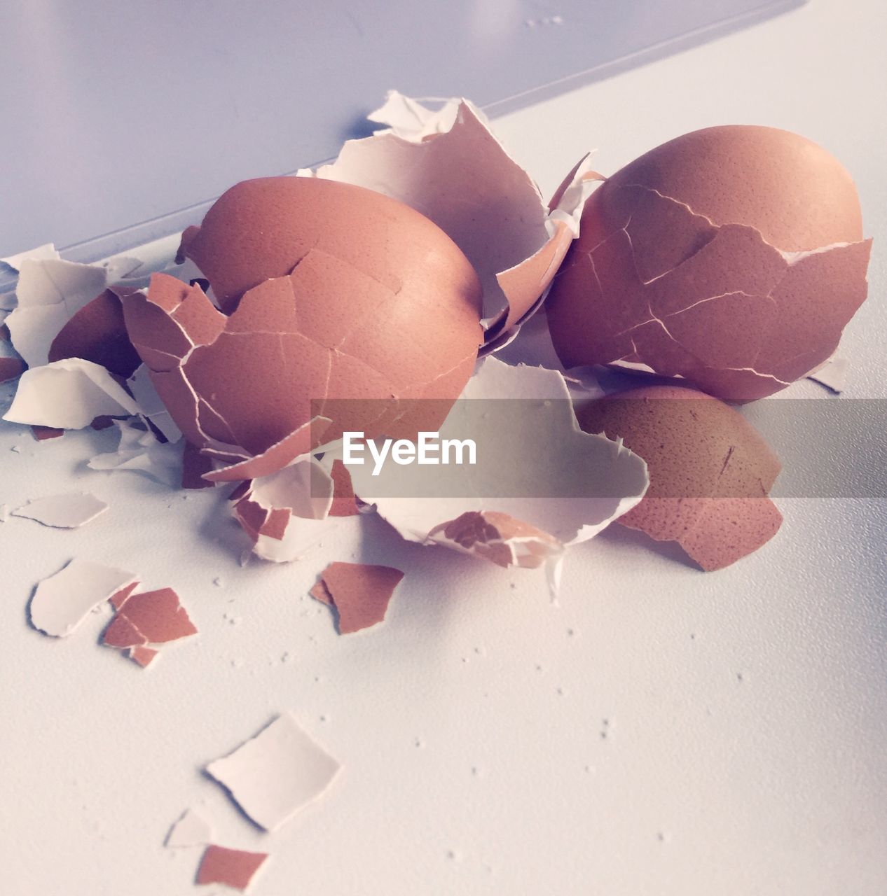 High angle view of cracked brown eggshell on table