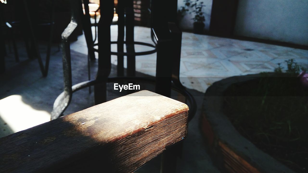 Sunlight falling on cropped wooden table