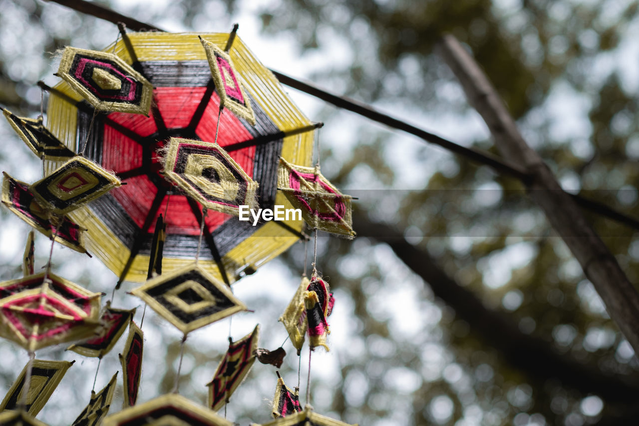 spring, no people, tree, hanging, low angle view, tradition, day, focus on foreground, nature, outdoors, religion, belief, flower, plant, close-up, decoration, leaf, branch, spirituality, protection, architecture