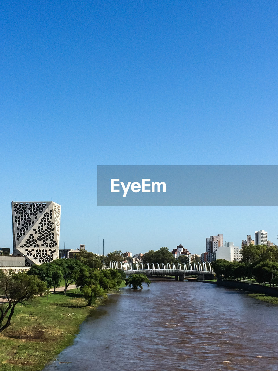 BRIDGE OVER RIVER AGAINST CLEAR BLUE SKY