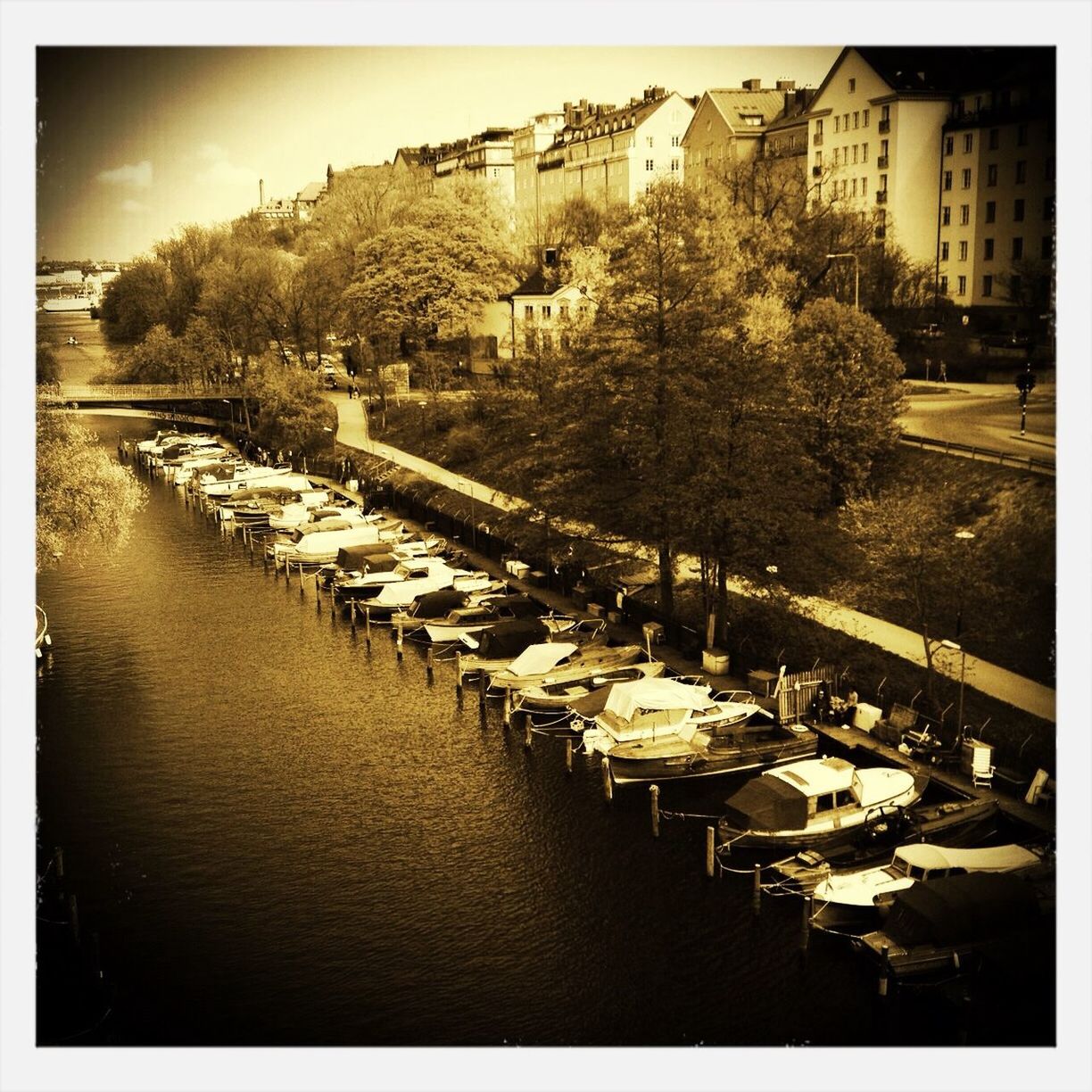 Boats moored in river against buildings