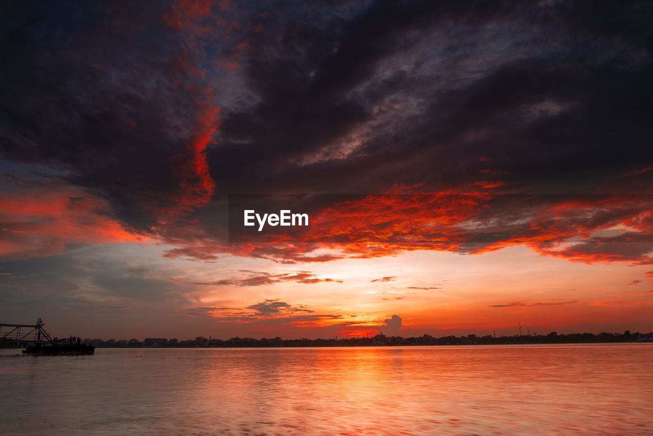 Scenic view of dramatic sky over sea during sunset