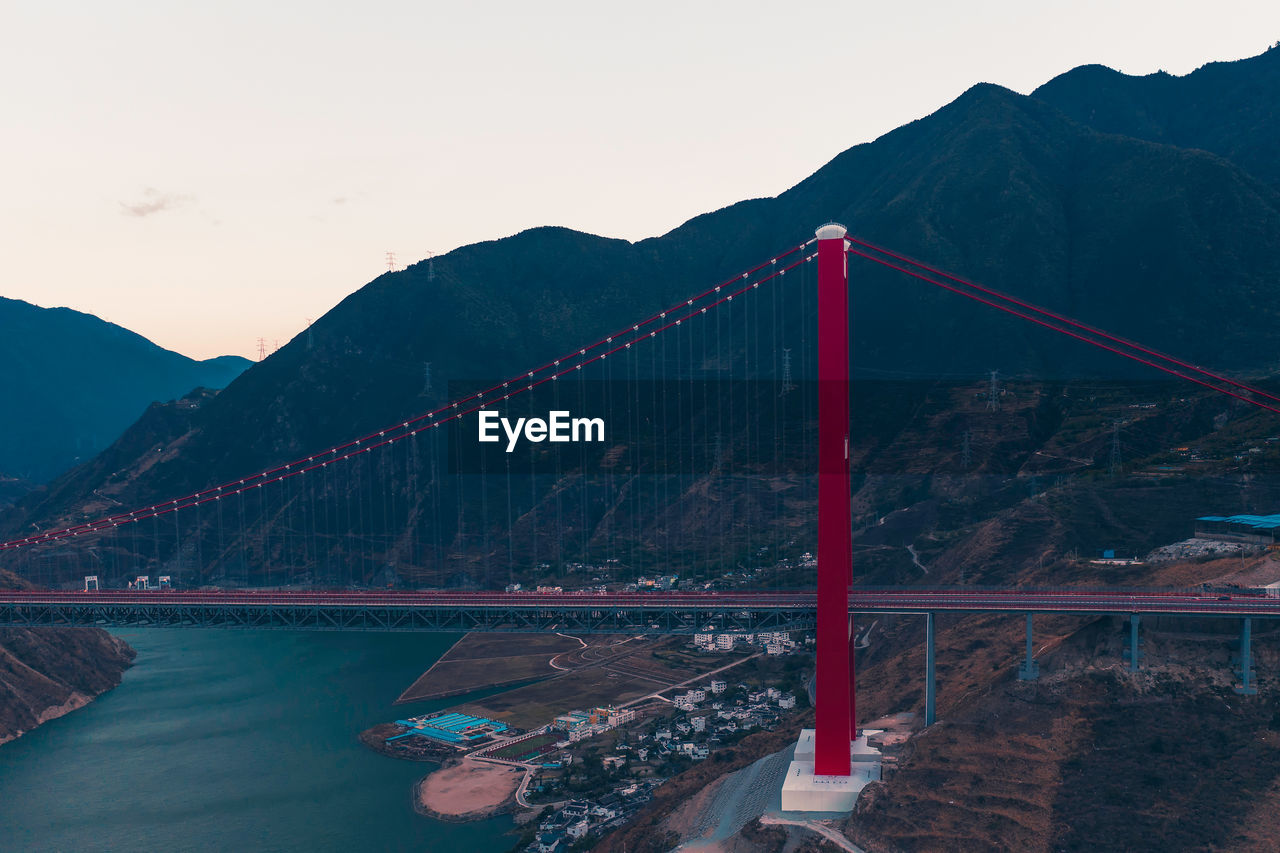 Bridge over river against mountain range