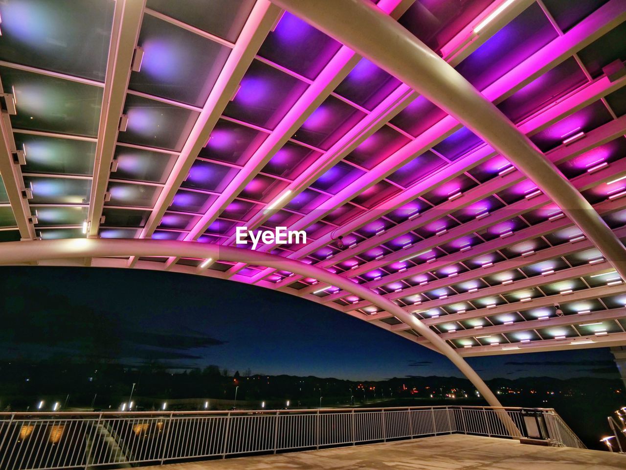 LOW ANGLE VIEW OF ILLUMINATED BRIDGE