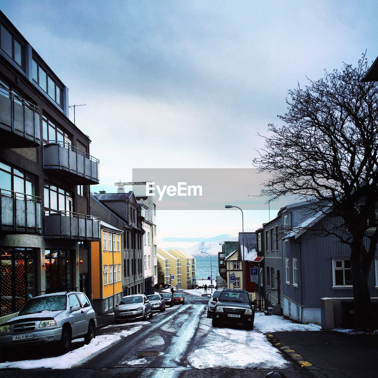 STREET AMIDST BUILDINGS AGAINST SKY