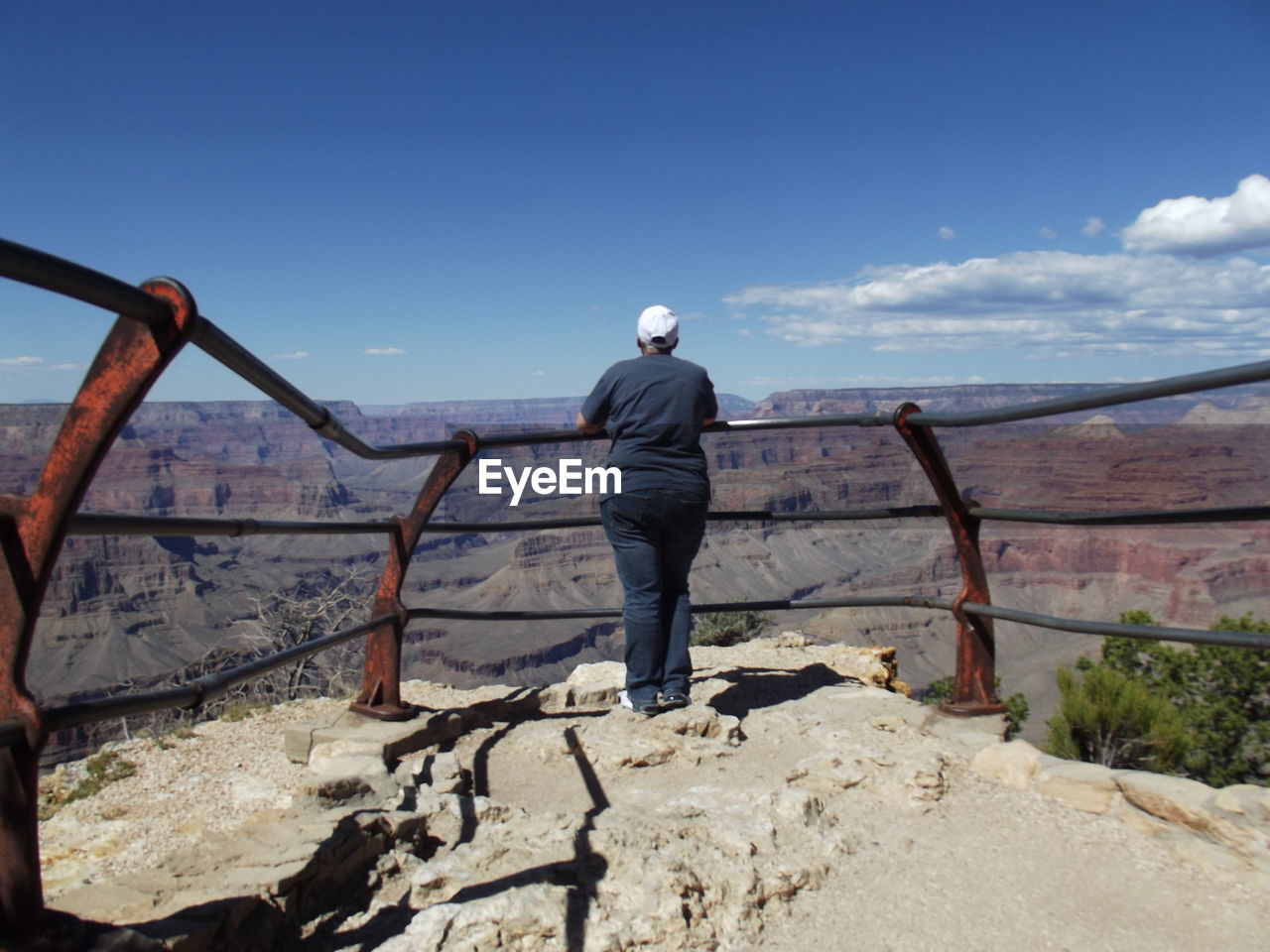 Rear view of woman standing on cliff at grand canyon national park