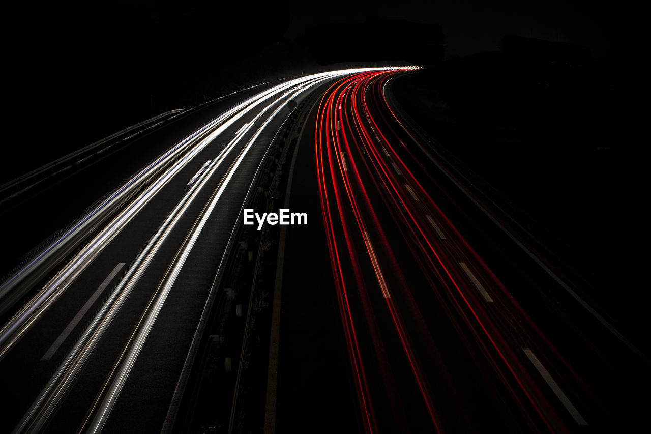 Light trails on road in city at night
